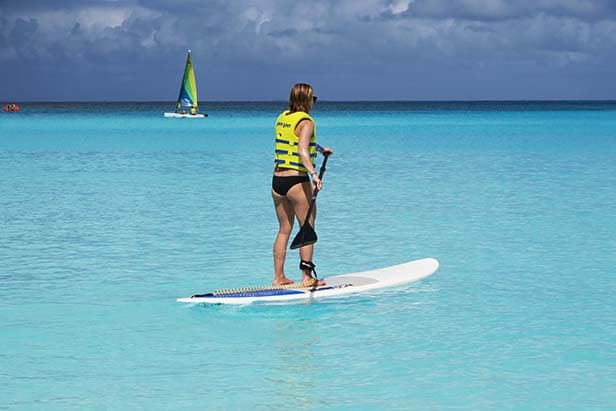 Sarah on a stand up paddle board in the ocean at Half Moon Cay