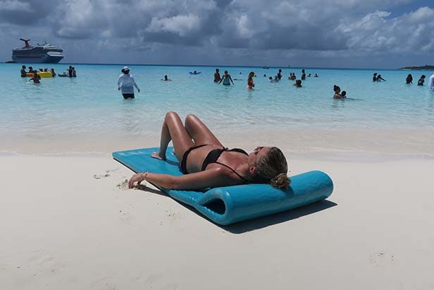 Woman laying on a beach float on the beach