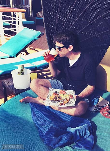 Randy sitting in half-shell cabana enjoying some food and a beer