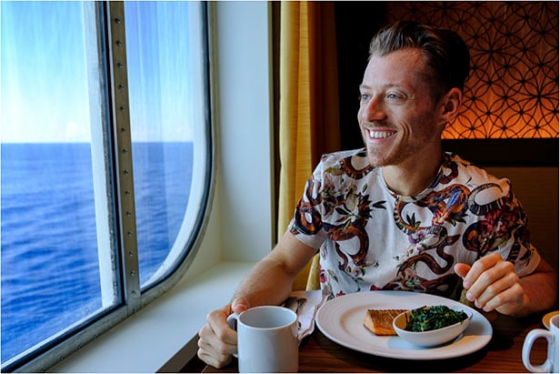 Jeremy eating dinner on Carnival Vista while looking out at the ocean