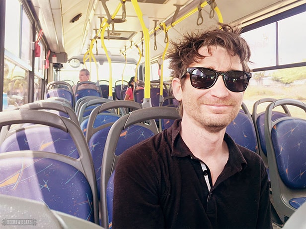 Randy wearing sunglasses and riding on a bus in Aruba