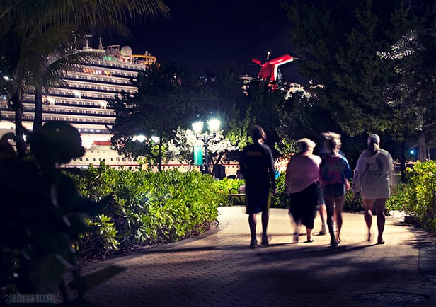 Group of people walking back to the Carnival Vista at night