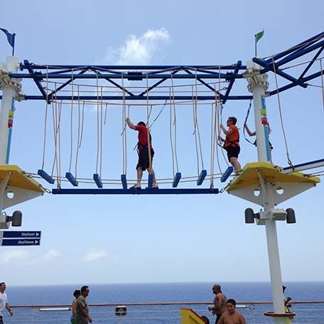 cruisers walking through the ropes course on a carnival ship