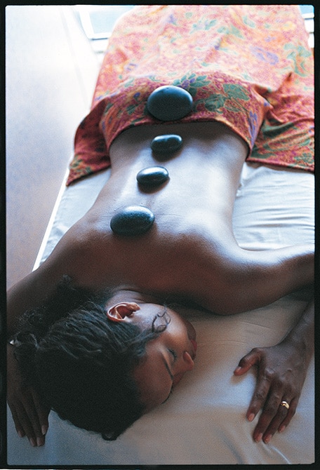 a woman receiving a hot stone massage