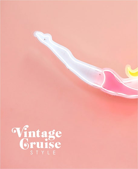 Pink background with figure swimming and text overlay stating Vintage Cruise Style 