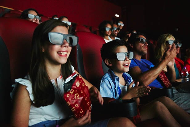 kids watching a 3-d movie at the imax theater onboard