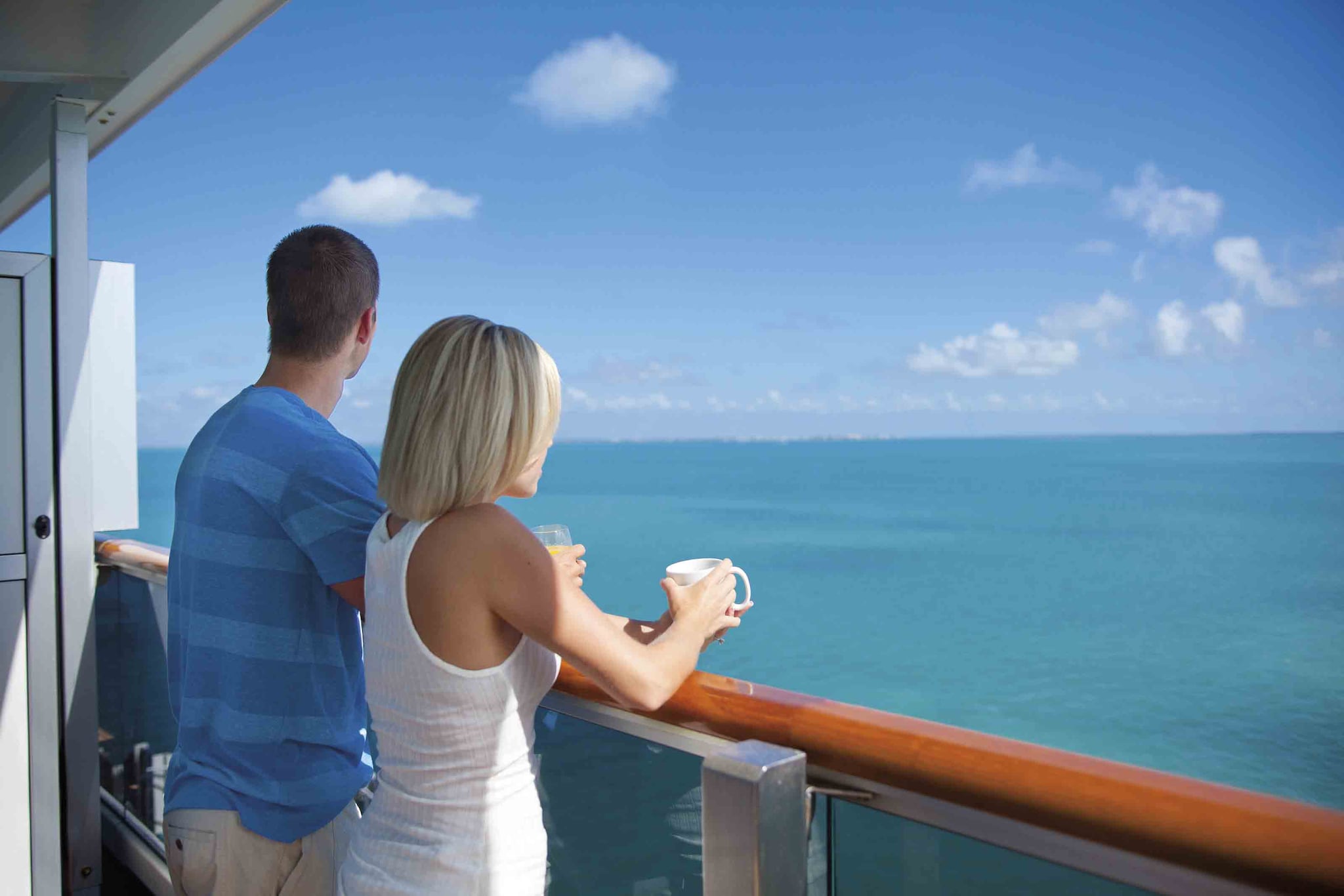 couple stands on cruise balcony