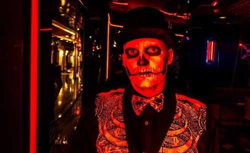 passenger in skull makeup during a halloween cruise