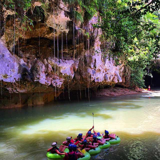a group cave tubing in belize