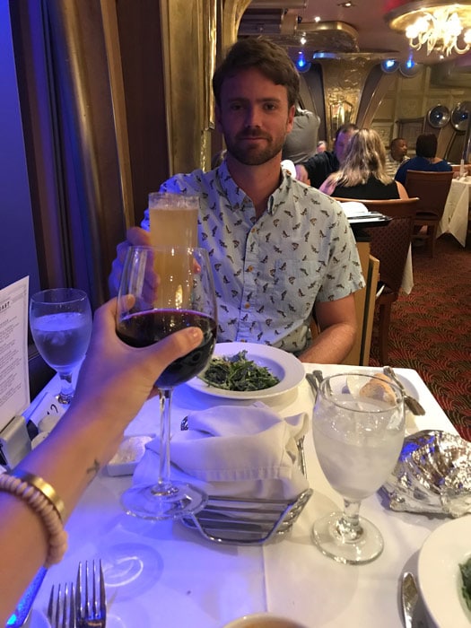 husband cheersing at dinner