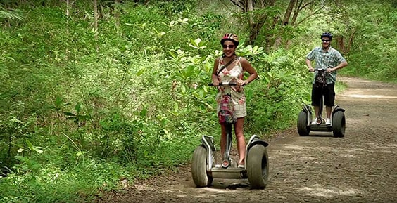 man and woman riding a segway on a rugged trail in st lucia