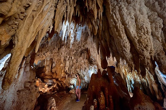 woman standing in the middle of crystal cave in grand cayman