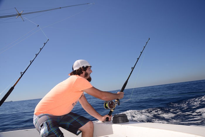 man holding a fishing rod as he bottom fishes off the coast of freeport