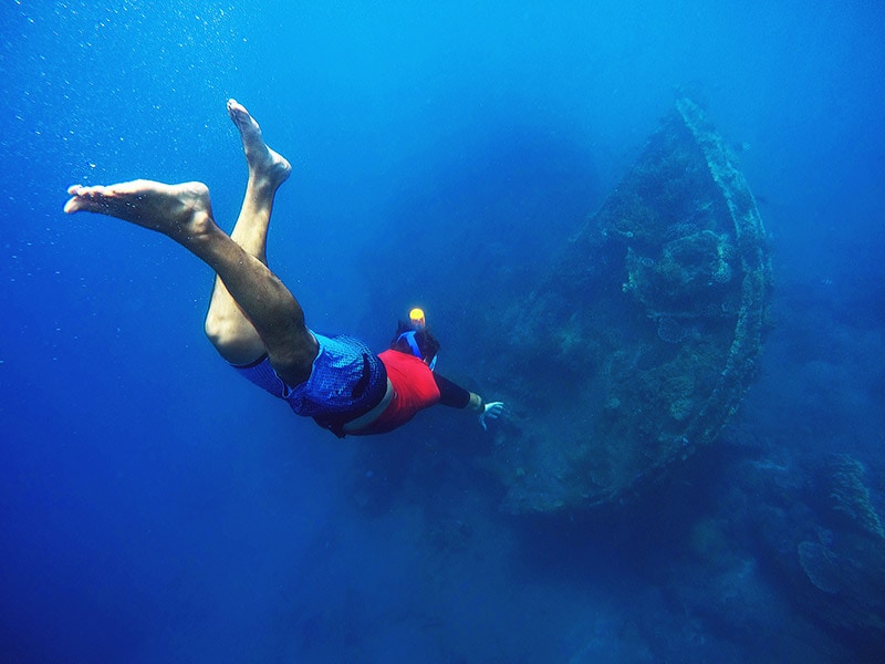 man snorkeling to a shipwreck off the coast of barbados