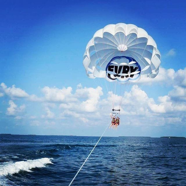 two people parasailing near the coast of key west