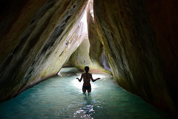 woman a walking narrow passage in The Baths, Virgin Gorda