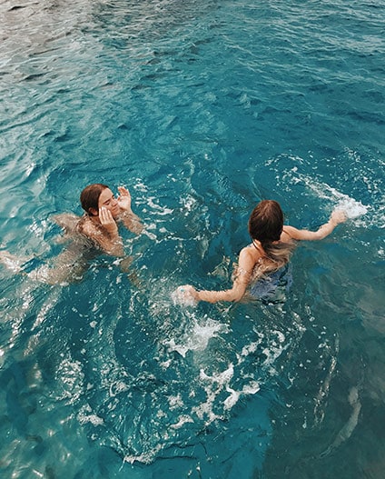 Tess & Sarah swimming on surface of water