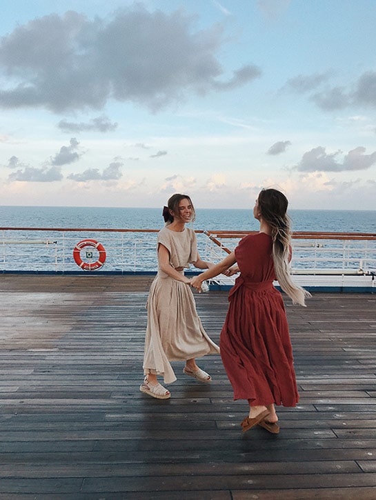 Tess & Sarah dancing on deck