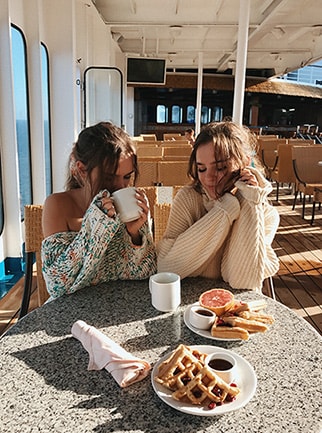 Tess & Sarah eat breakfast on the deck
