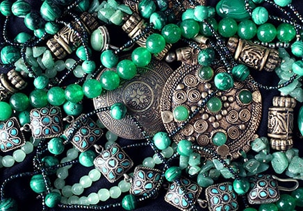 several pieces of jewelry made from emerald