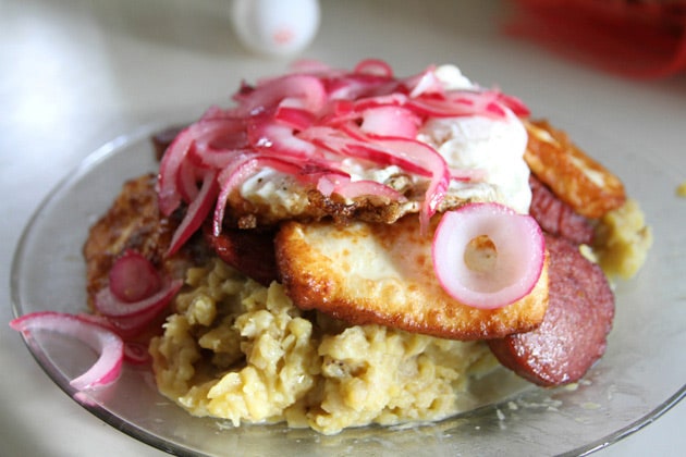 mangu served with eggs, sausage, and onions