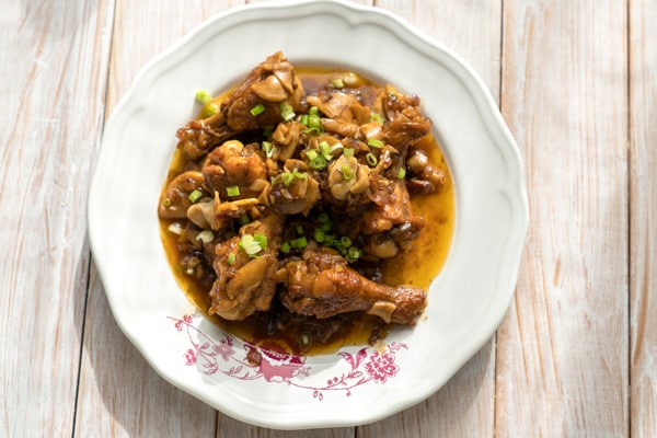 dominican pollo guisado – chicken stew – served on a white bowl
