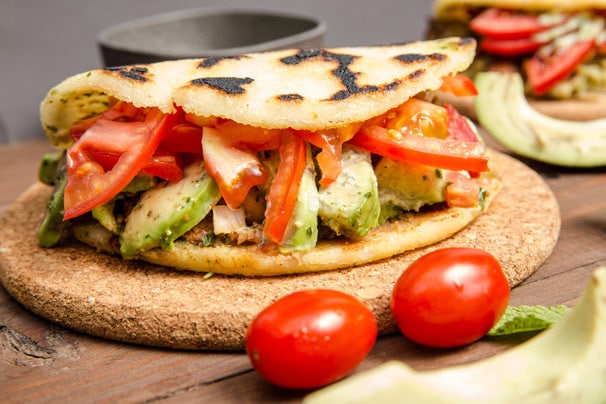 curacao arepa stuffed with avocado, tomatoes, and meat