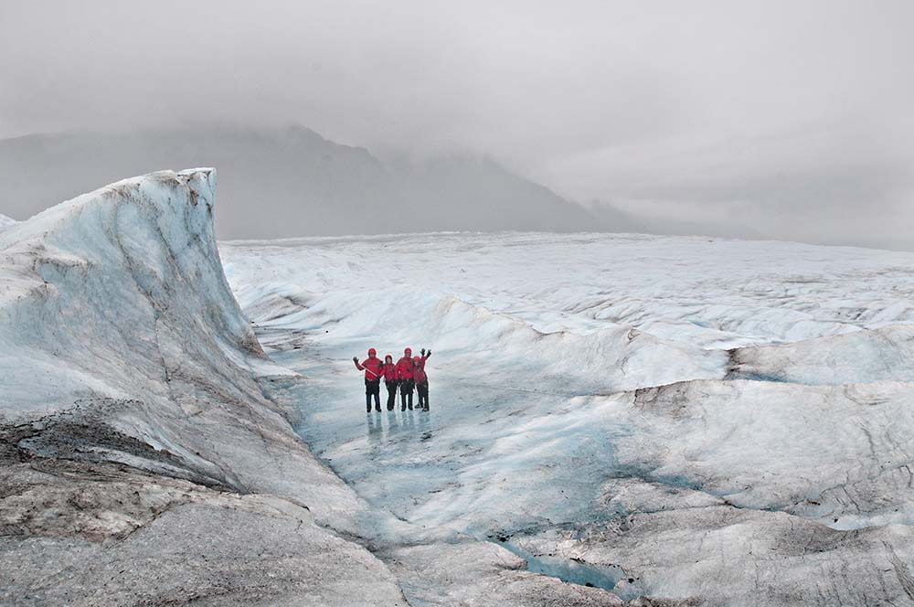 four friends exploring the glaciers in juneau