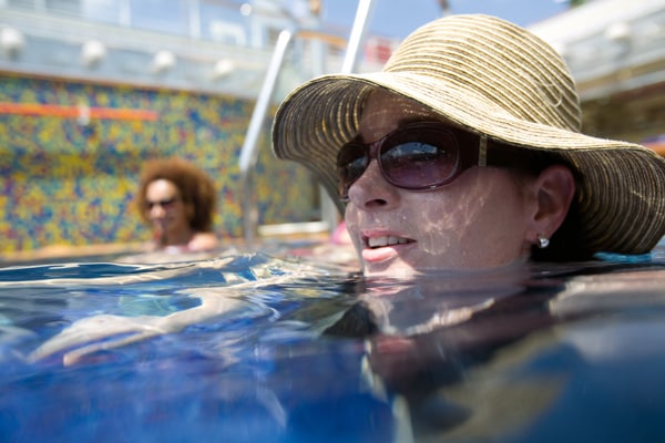 woman wearing sunglasses and hat in carnival pool