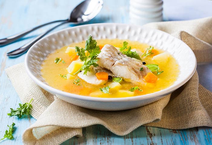 sopi pisa, popular fish soup from bonaire, served in a white bowl