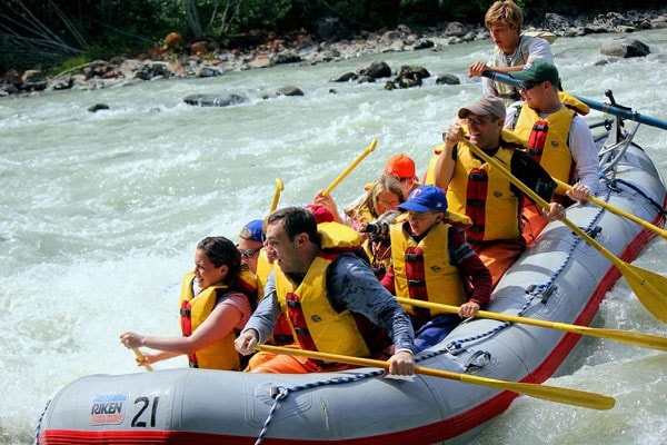 group of people whitewater rafting through the mendenhall river