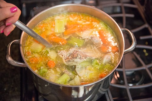 sancocho made with chicken and vegetables from dominica being cooked on the stove
