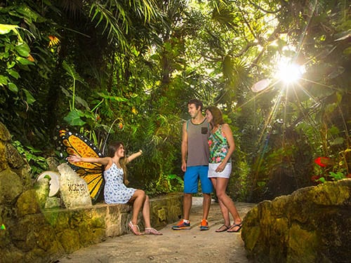 father and mother talking to daughter as they explore xcaret park