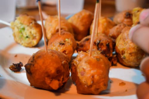 conch fritters from key west served with a wooden stick