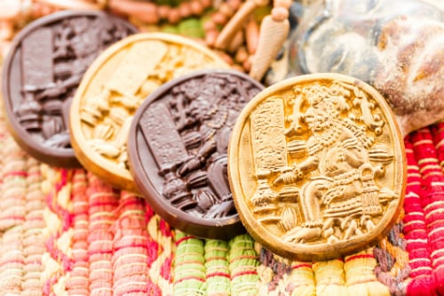 gold and brown mexican chocolate with mayan hieroglyphs