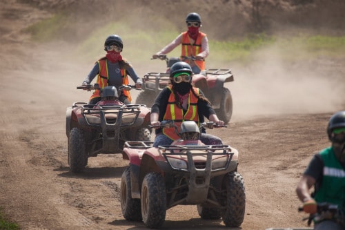 3 people riding red atv as they take a wine country tour in the calafia valley