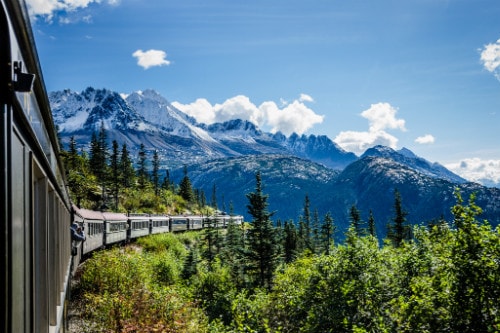view of the yukon landscape on board a train as it heads to the white pass in skagway