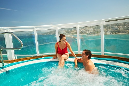 couple enjoying the jacuzzi in serenity adults only retreat with an amazing view of the caribbean