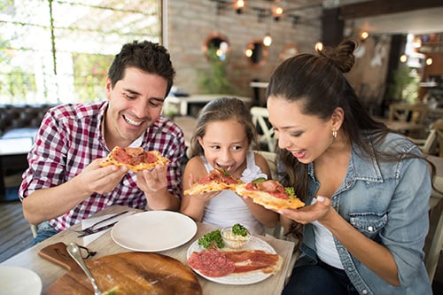family eating pizza in an italian restaurant in baltimore’s little italy 