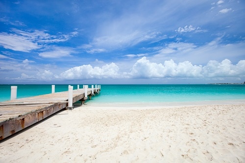 wooden pier in beautiful freeport beach in the bahamas 