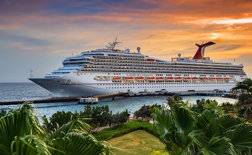 carnival conquest docking in the southern caribbean port of curacao as the sun sets