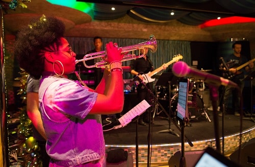 woman playing the trumpet in a carnival ship during new years 