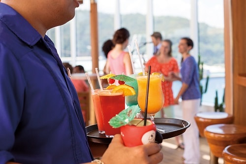 bartender handing out specialty drinks on carnival paradise 