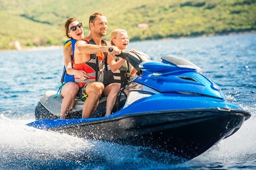 parents and their child enjoying a jet ski ride in st maarten