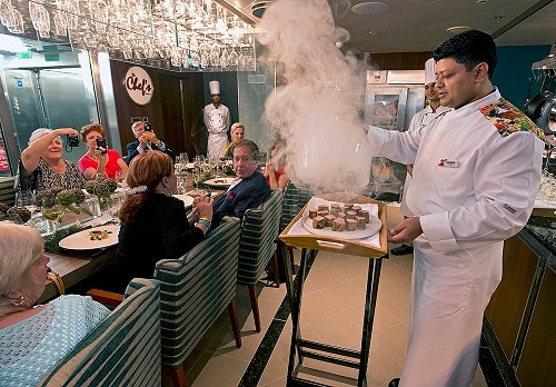 chef serving freshly made steak at the chef’s table on carnival spirit