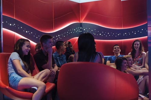 teenagers talking and laughing in club 02 on carnival spirit