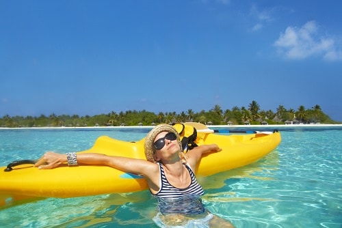 woman resting on her kayak during her shore excursion in the bahamas
