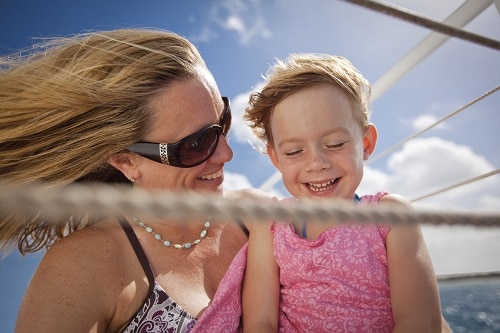 mother and her child enjoying the sea breeze onboard a carnival ship