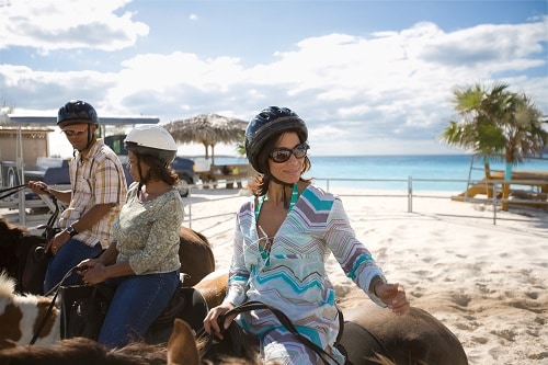 guests getting ready to go on a horse back adventure in the caribbean
