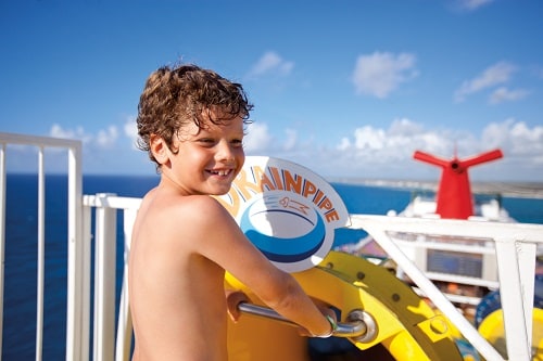 boy ready to go down a water slide from waterwords onboard carnival dream